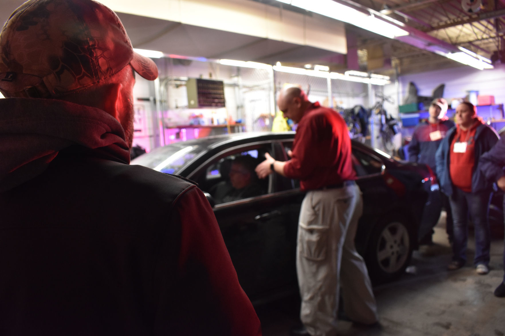 Chad Crary watches Brian Fehd demonstrate traffic stop